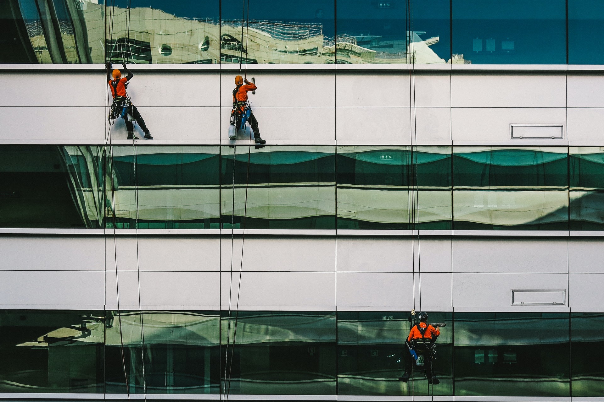 man cleaning white building